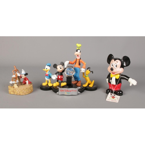 103 - Three Disney figures, to include Walt Disney World 2000 figure group watch stand with watch and Disn... 