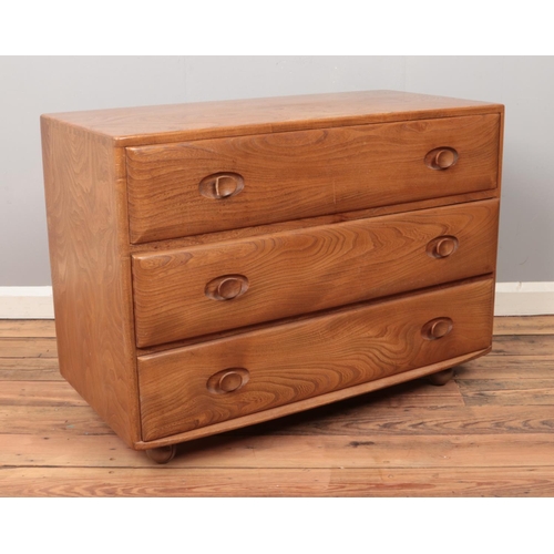 511 - A small Ercol chest of three drawers. Height 66cm, Length 92cm, Depth 44cm.