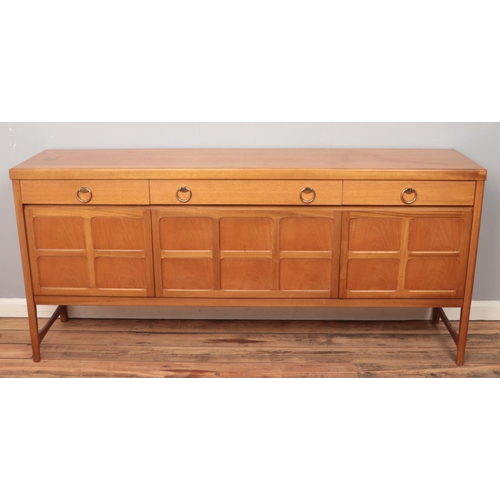 513 - A Nathan teak sideboard with four drawers over panelled cupboard doors. Height 84cm, Length 183cm, D... 