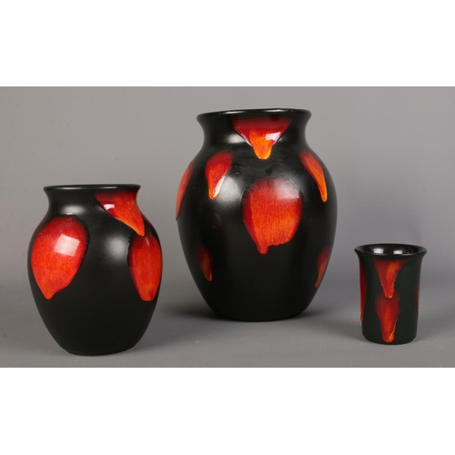 123 - Three pieces of Poole pottery in the 'Cosmic Drip' lava pattern. To include large baluster shaped va... 