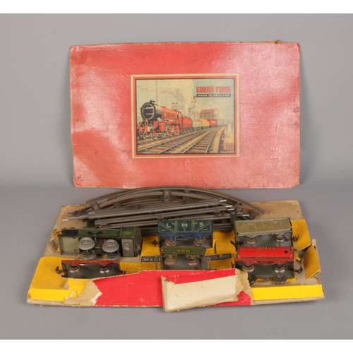 131 - A Goods clockwork train set with freight cars and track. With box however box is badly damaged.