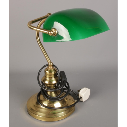 141 - A brass desk lamp with green glass shade.