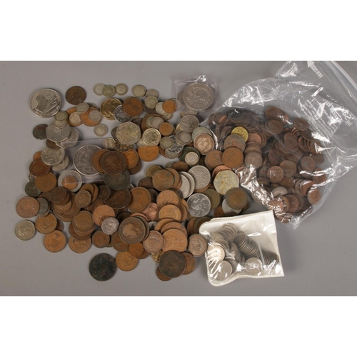 148 - A box of British coins. Includes sixpences, threepences, five pound coins, 1788 token etc.