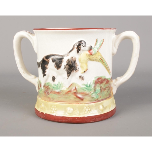 163 - A Staffordshire twin-handled frog mug featuring pheasant hunting decoration.