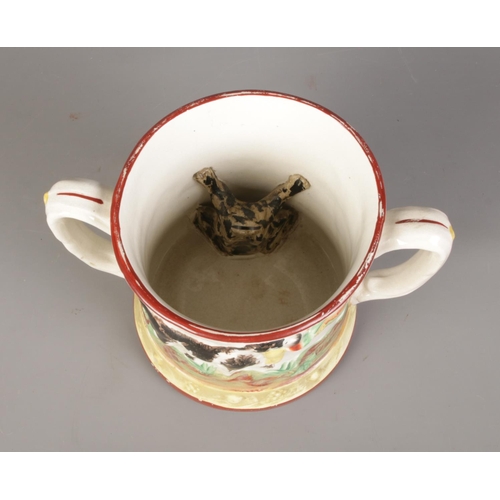 163 - A Staffordshire twin-handled frog mug featuring pheasant hunting decoration.