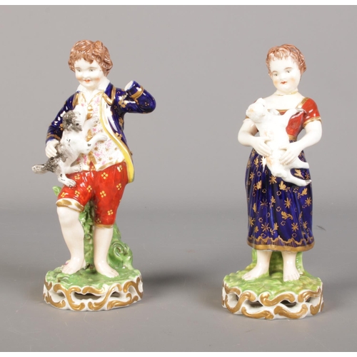 165 - A pair of Derby figures depicting young boy and girl holding a lamb and dog. Young boy is missing le... 