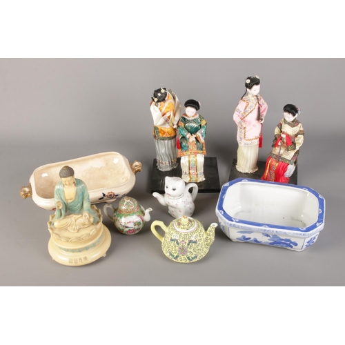 185 - A box of assorted oriental ceramics including tea pots and bonsai planter along with pair of figures... 