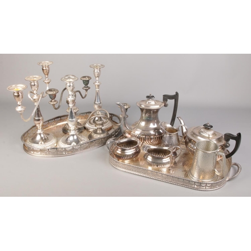 65 - A good collection of silver plate. Includes two gallery serving trays, candelabra, Viners tea set et... 