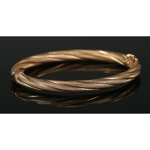 310 - A 9ct Gold bangle with rope twist decoration. Total weight: 9.13g