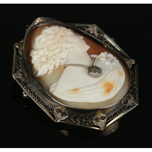 311 - An egg-shaped cameo brooch portrait of a lady, wearing diamond pendant necklace, with 14ct Gold pin ... 