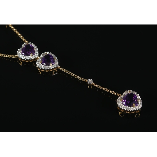 317 - A diamond heart shaped drop-pendant necklace, set with three amethyst coloured stones, on 18ct Gold ... 