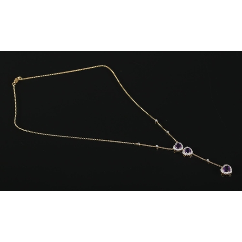 317 - A diamond heart shaped drop-pendant necklace, set with three amethyst coloured stones, on 18ct Gold ... 