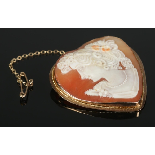 319 - A 9ct Gold mounted cameo heart-shaped brooch, with safety chain.