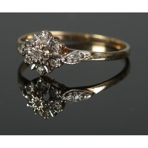 324 - A boxed 9ct diamond cluster ring. Size P 1.32g.