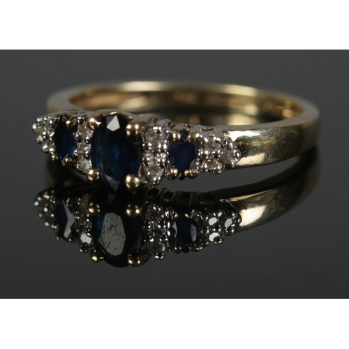 325 - A boxed 9ct diamond and sapphire ring. Size N 21.9g.