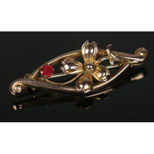 334 - A 9ct gold ruby floral brooch. 1.45g