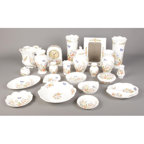 76 - A large collection of Aynsley Cottage Garden ceramics. To include quartz clock, large vase, bowls an... 