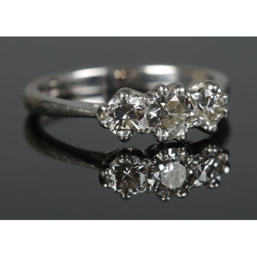 359 - An 18ct White Gold and Three Stone Diamond ring (approximately 0.9ct in total). Assayed London, 2005... 