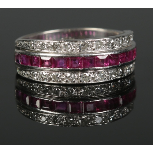 366 - An 18ct White Gold channel set ruby and diamond ring. Size M½. Total weight: 6.22g