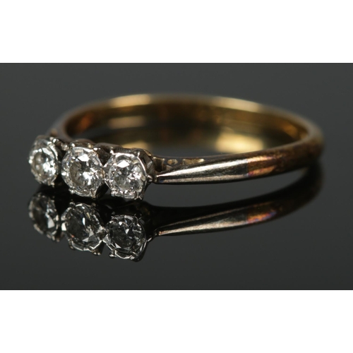 373 - A 18ct gold and platinum three stone diamond ring with box. Size O 2.3g.