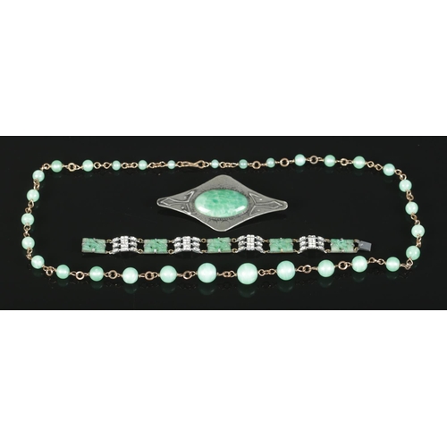 382 - A collection of Peking Glass jewellery. To include necklace, large brooch and carved bracelet.