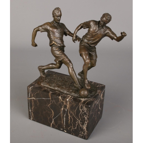 79 - After Milo, A bronze figure group of footballers. Raised on marble plinth. (24cm)