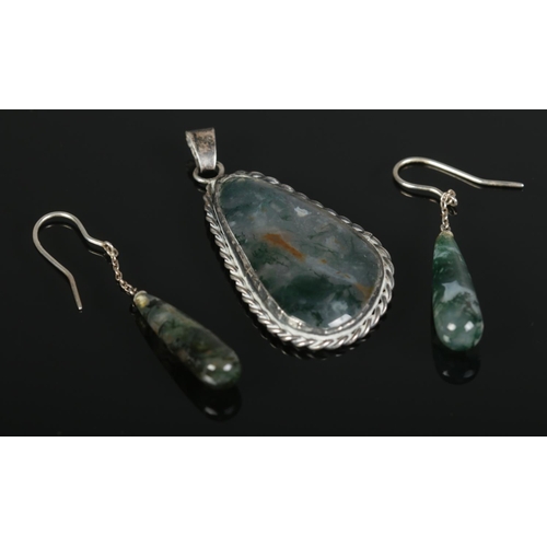 384 - A silver moss agate pendant, together with a pair of similar earrings.