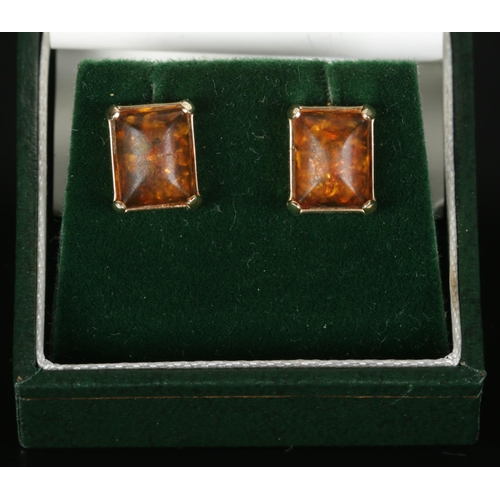 385 - A pair of 9ct Gold and amber ear studs, with NODA certificate. Total weight: 2.73g