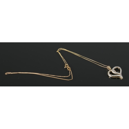 386 - A 9ct Gold and Diamond heart shaped pendant, on 9ct Gold chain. Total weight: 2.57g