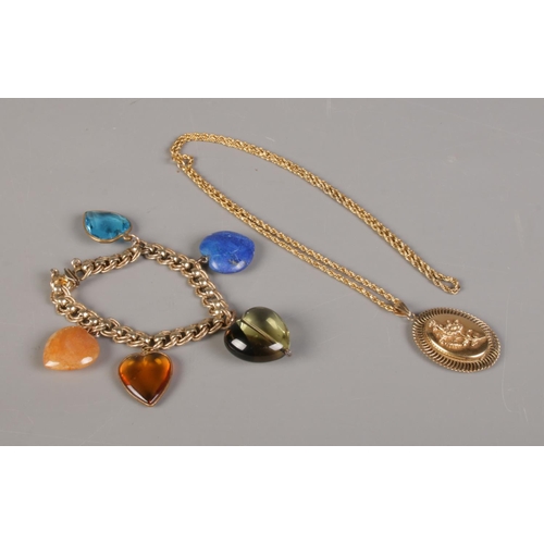 389 - A rolled gold charm bracelet, together with a rolled gold locket and chain.