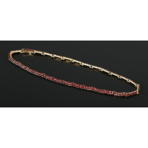 393 - A silver gilt garnet necklace, stamped 900 to the clasp.