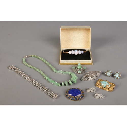 403 - A quantity of costume jewellery, to include boxed bangle marcasite set examples, brooches and neckla... 