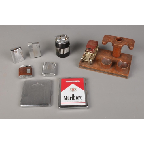 82 - A quantity of smoking items including novelty pipe stand featuring model of a car, cigarette cases i... 