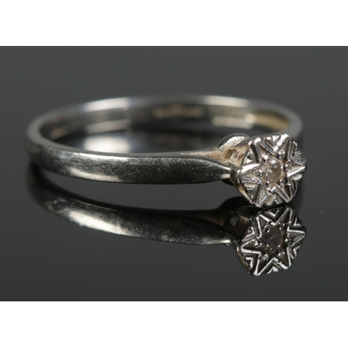 423 - A platinum and diamond illusion set solitaire ring. 2.37g. Size L 1/2.