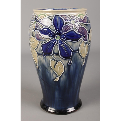 424 - A Royal Doulton stoneware vase with tubelined floral decoration. 20.5cm.