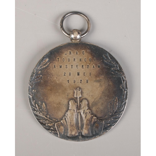 425 - A Dutch white metal footballers medal, enscribed 'Hij Zit' and 'voetbalwedstrijd' (He Sits, Football... 