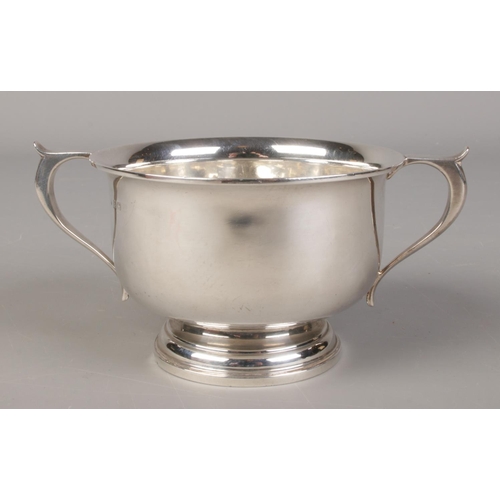 432 - A George V silver twin handled pedestal bowl. Assayed Birmingham 1925 by Charles S Green & Co Ltd. 1... 