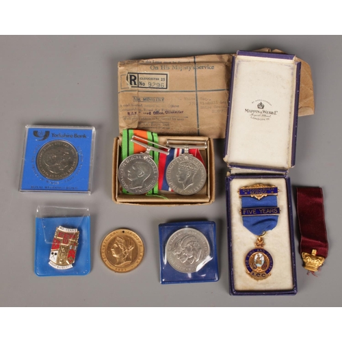 435 - A quantity of medals and coins. Including The Defence Medal, War Medal, etc.