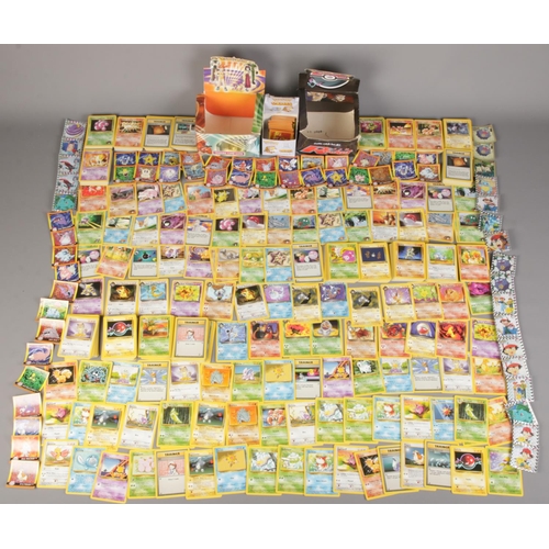 443 - A large quantity of loose Pokémon cards and stickers along with original Team Rocket booster pack di... 