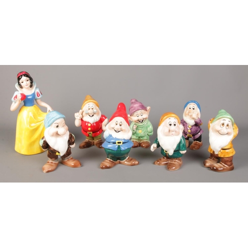 90 - A complete of Disney Japan Snow White and the Seven Dwarfs ceramic figures. Tallest: 28cm.