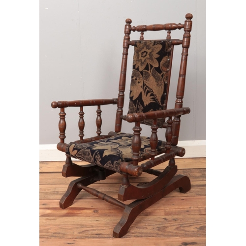 479 - A mahogany child's American rocking chair, with turned bobbin supports and two bobbin stretchers.