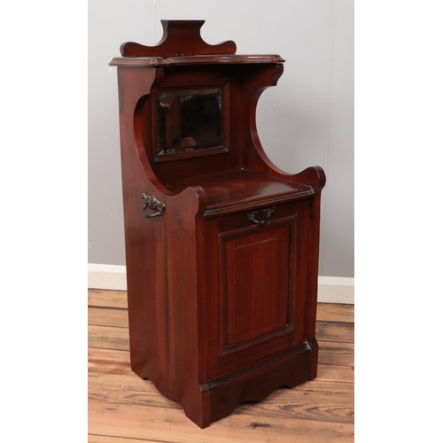 484 - A mahogany perdonium with bevelled mirror back.