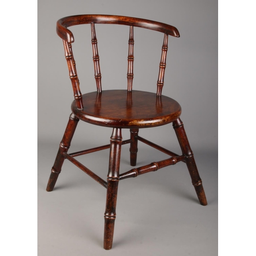 485 - An antique child's arm chair with faux bamboo supports.