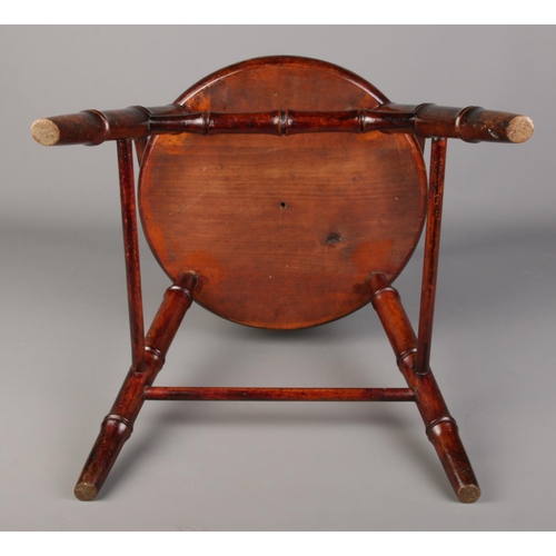 485 - An antique child's arm chair with faux bamboo supports.