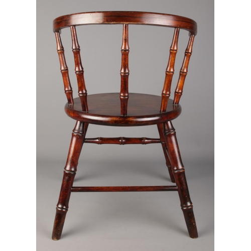 485 - An antique child's arm chair with faux bamboo supports.