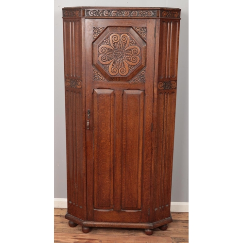 489 - A carved oak hall robe. With floral decoration. (182cm x 90cm)