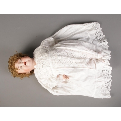 175 - An Armand Marseille bisque doll. Stamped 996 A9M. Approx. 51cm tall.