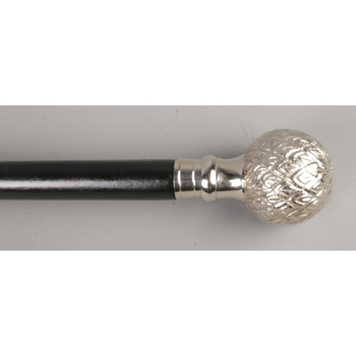 34 - An ebony walking cane with white metal engraved top.