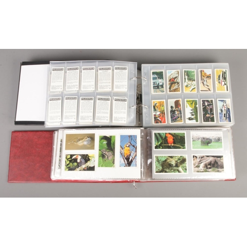 86 - Three large albums containing over 3000 Brooke Bond tea cards, together with an album containing Hen... 