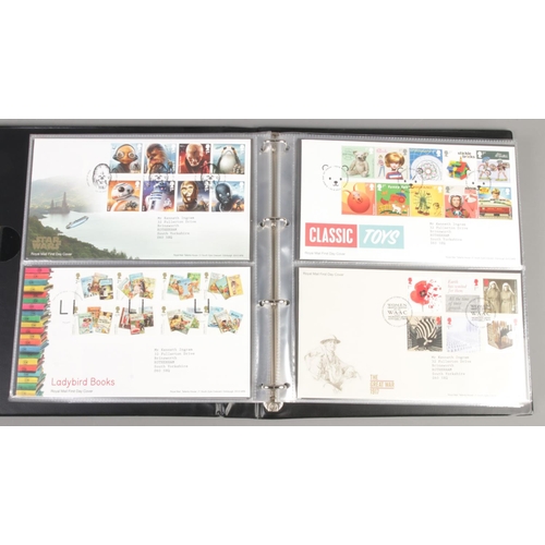 93 - An album of Royal Mail first day covers. Including Marvel, Harry Potter, David Bowie, Pink Floyd, et... 